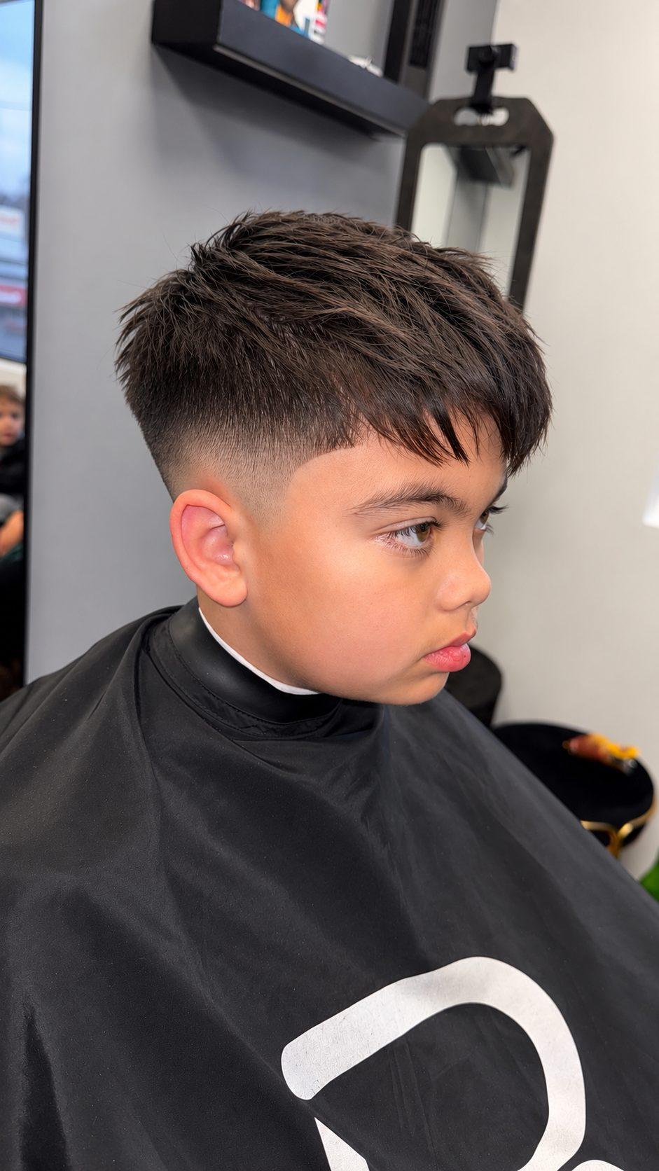 Kids mid skin fade with textured top at Eminence Barbersuite, North Plainfield NJ