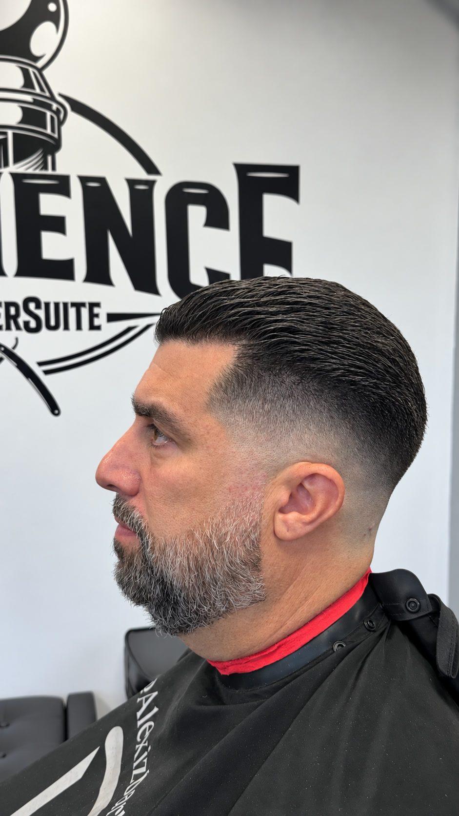 Mid skin fade slick back with beard at Eminence Barbersuite, North Plainfield NJ